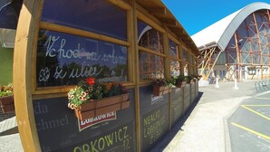 A building with large windows, wooden frames, and flower boxes. - Hotel Gól Prostějov (Prostejov)