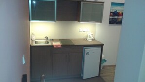 A small kitchenette with a sink, a kettle, and a refrigerator. - Hotel Gól Prostějov (Prostejov)