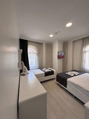 Standard Triple Room | Premium bedding, minibar, in-room safe, laptop workspace