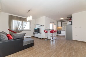 Apartment, Sea View (A4) | Living area | Flat-screen TV - Apartments Kovacevic (Vir)