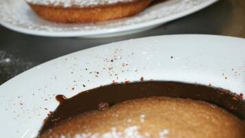 Two plates with a dessert topped with powdered sugar.