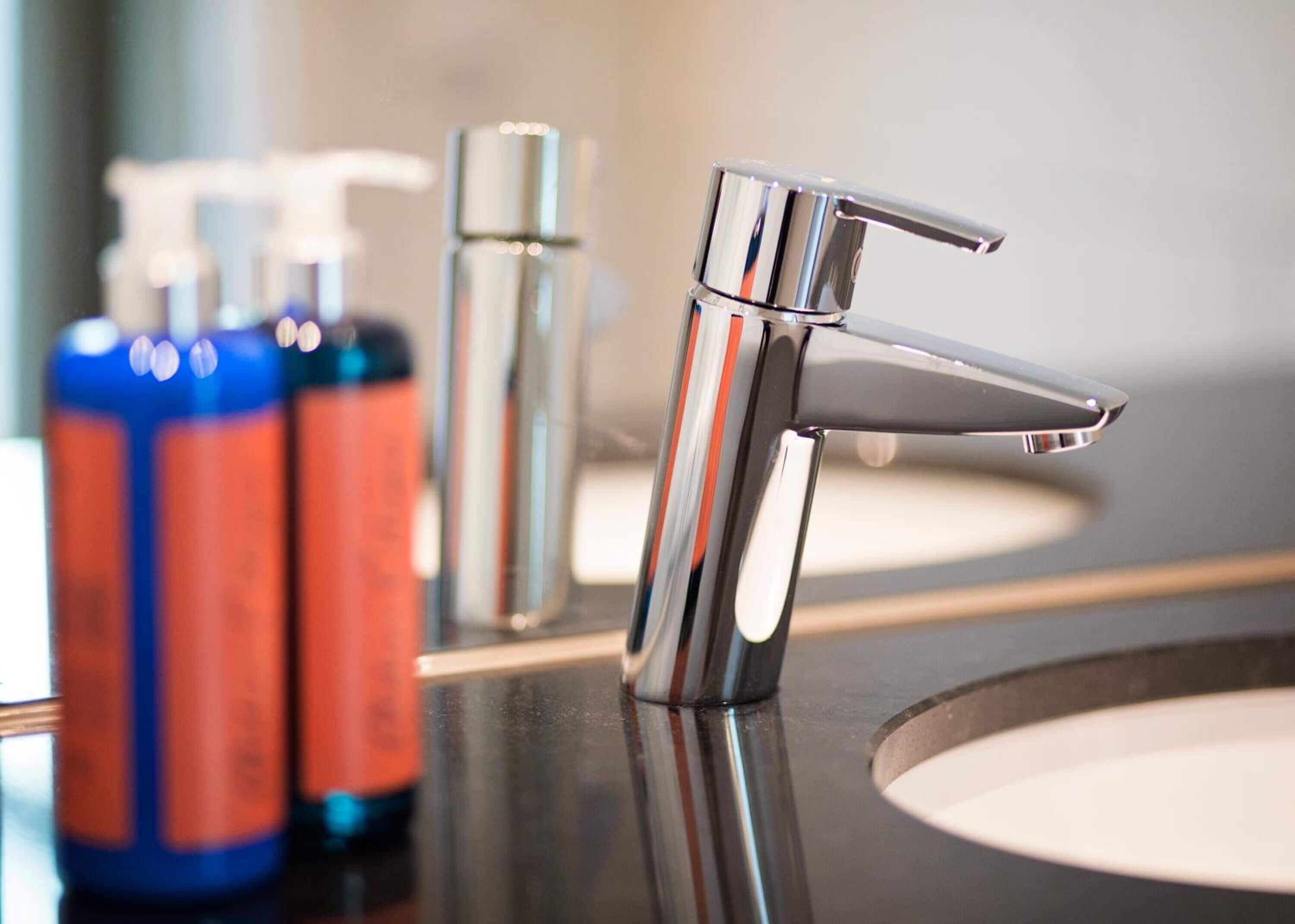 shower, hair dryer, slippers, towels