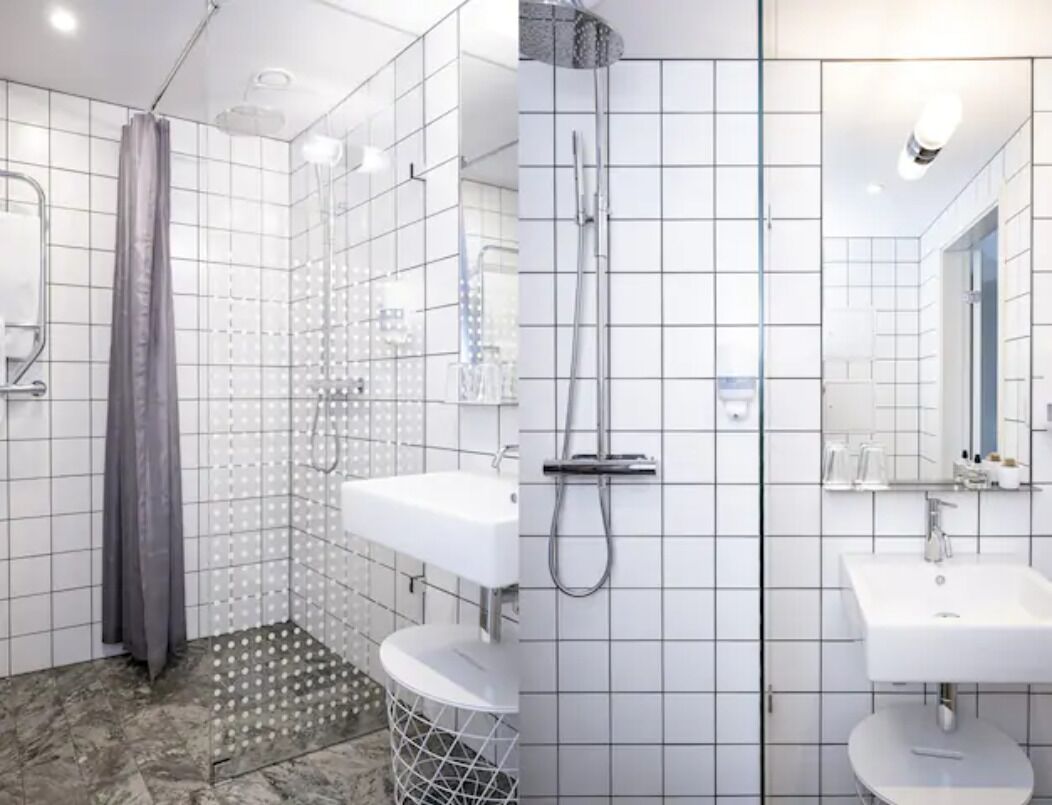 A modern bathroom with a shower, two sinks, and a mirror.