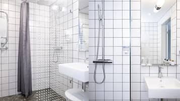 A modern bathroom with a shower, two sinks, and a mirror.