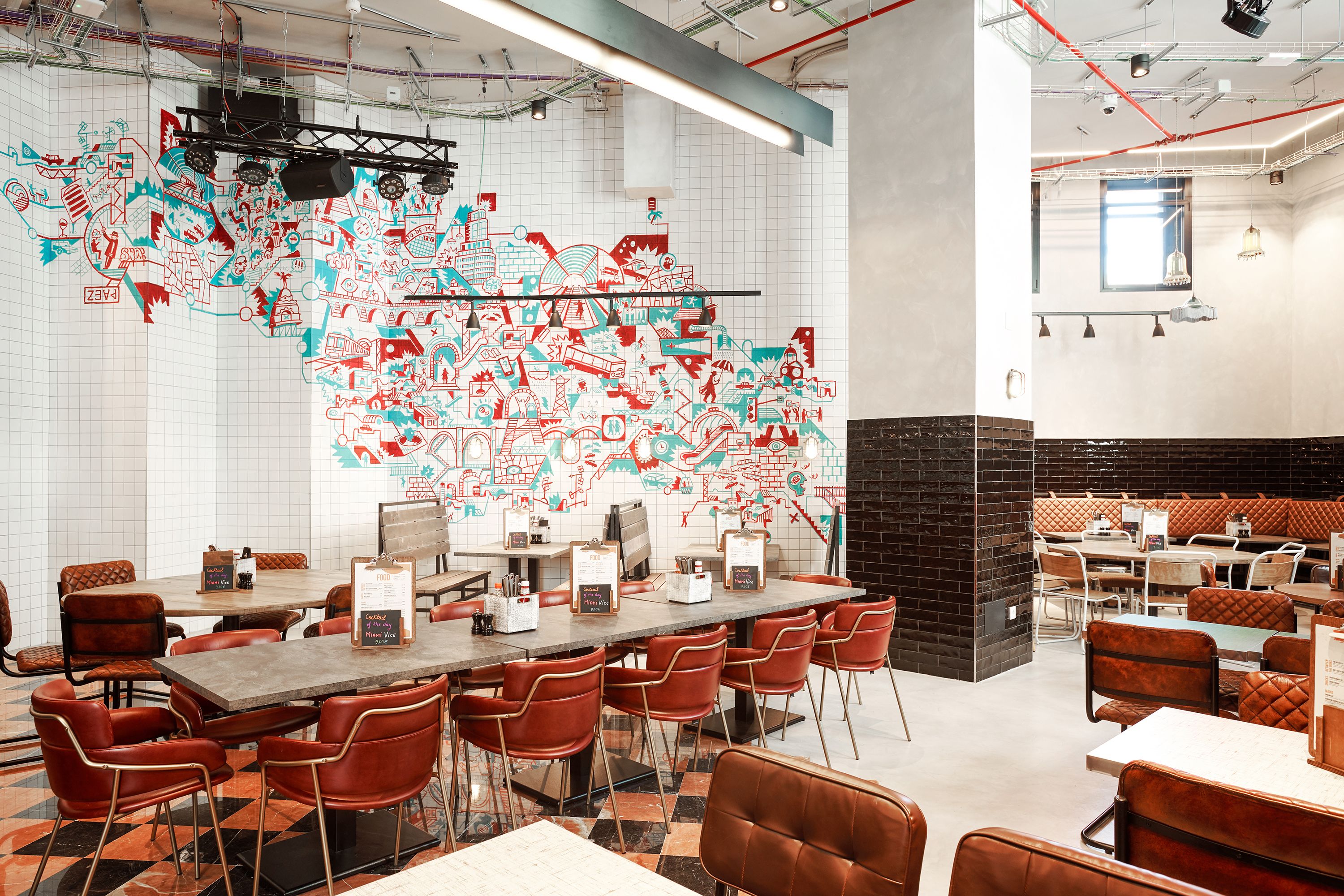 A restaurant with a large mural on the wall, multiple tables and chairs, and a modern interior design.