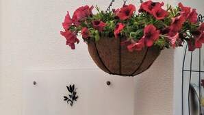 A sign for 'Suites Inn Lagos' with a hanging flower basket above it. - Suites Inn Lagos (Lagos)