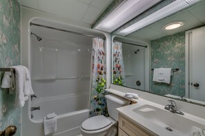 A bathroom with a bathtub, toilet, and sink. - Sea Watch Resort by Condo-World (Myrtle Beach)