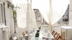 A dining area with a long table set for a meal, surrounded by chairs. - B&B Il Borgo (Poggiardo)