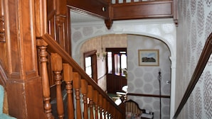 A wooden staircase with ornate balusters leading to an upper floor. - The Gables (Bathgate)
