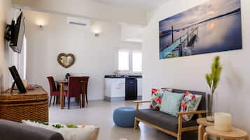 Bungalow, 1 Bedroom, Patio, Poolside | Living area | 32-inch flat-screen TV with cable channels, TV