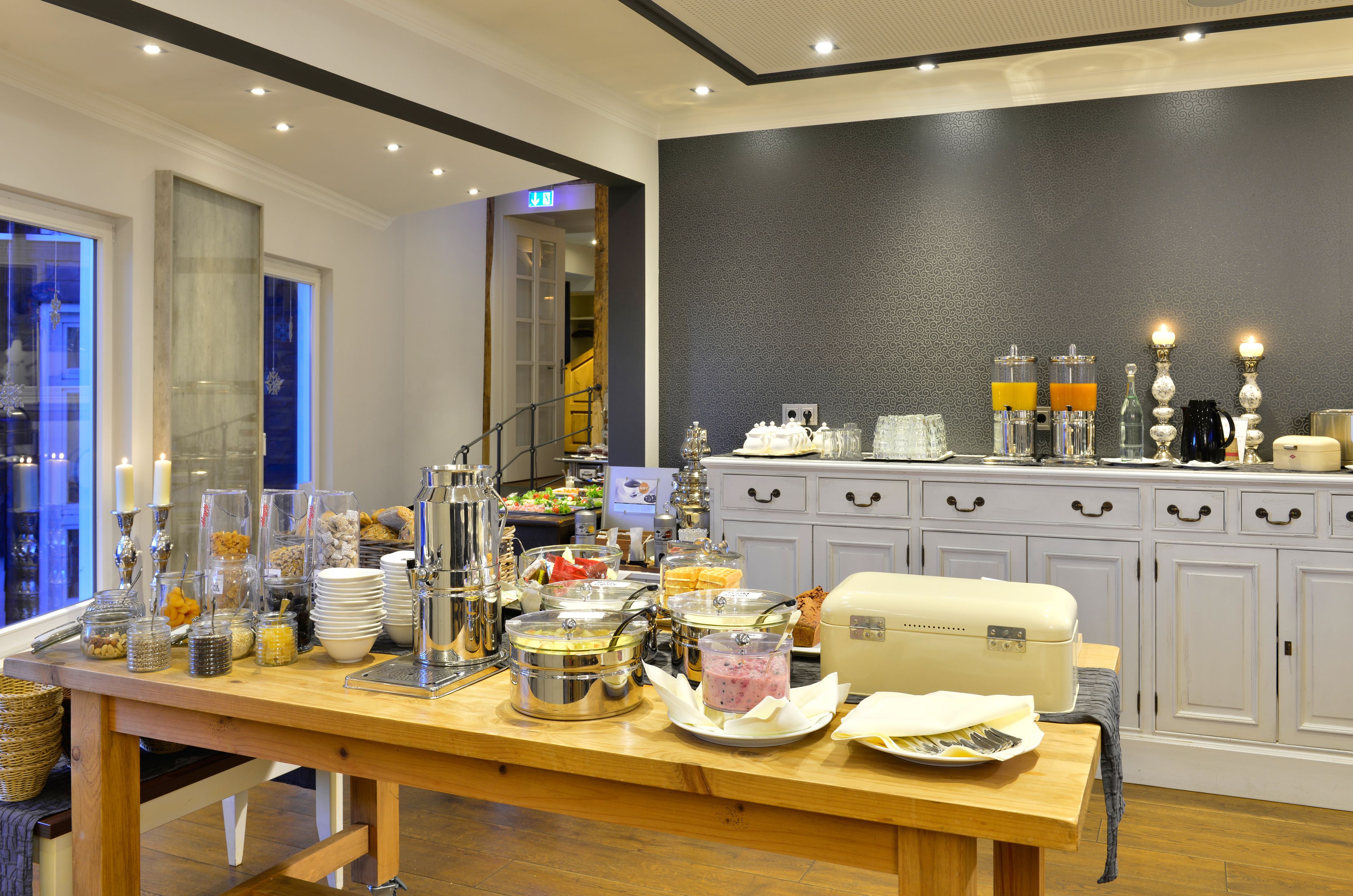A buffet setup with various food items and beverages.