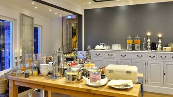 A buffet setup with various food items and beverages.