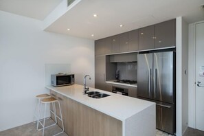 Executive Apartment | Private kitchen | Full-size fridge, microwave, oven, stovetop - Accommodate Canberra - Lakefront (Kingston)