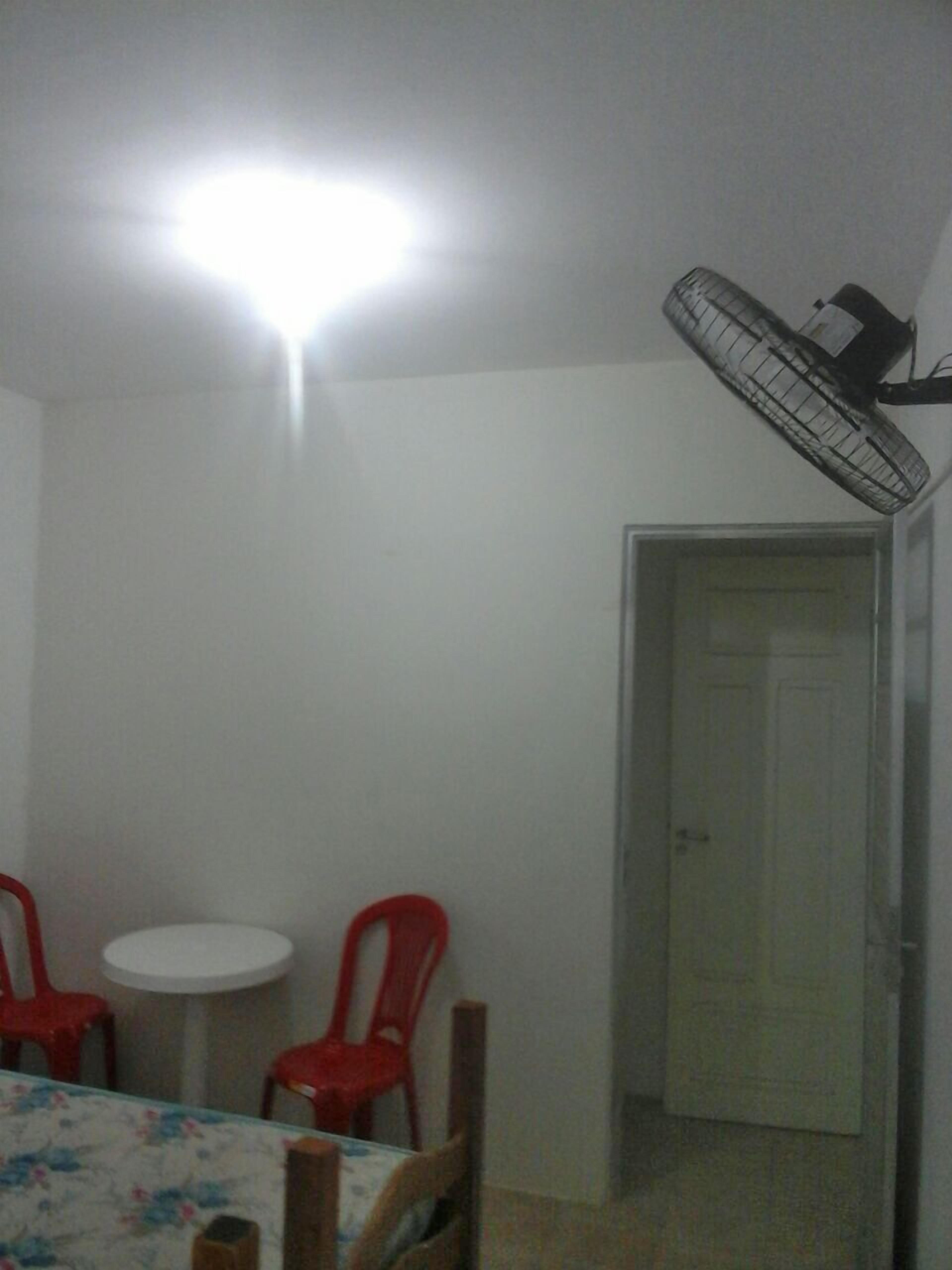 Ein Essbereich mit Tisch, Stühlen und Deckenventilator.