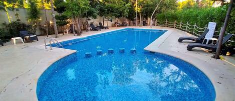 Outdoor pool, open 6 AM to 9 PM, pool umbrellas, pool loungers