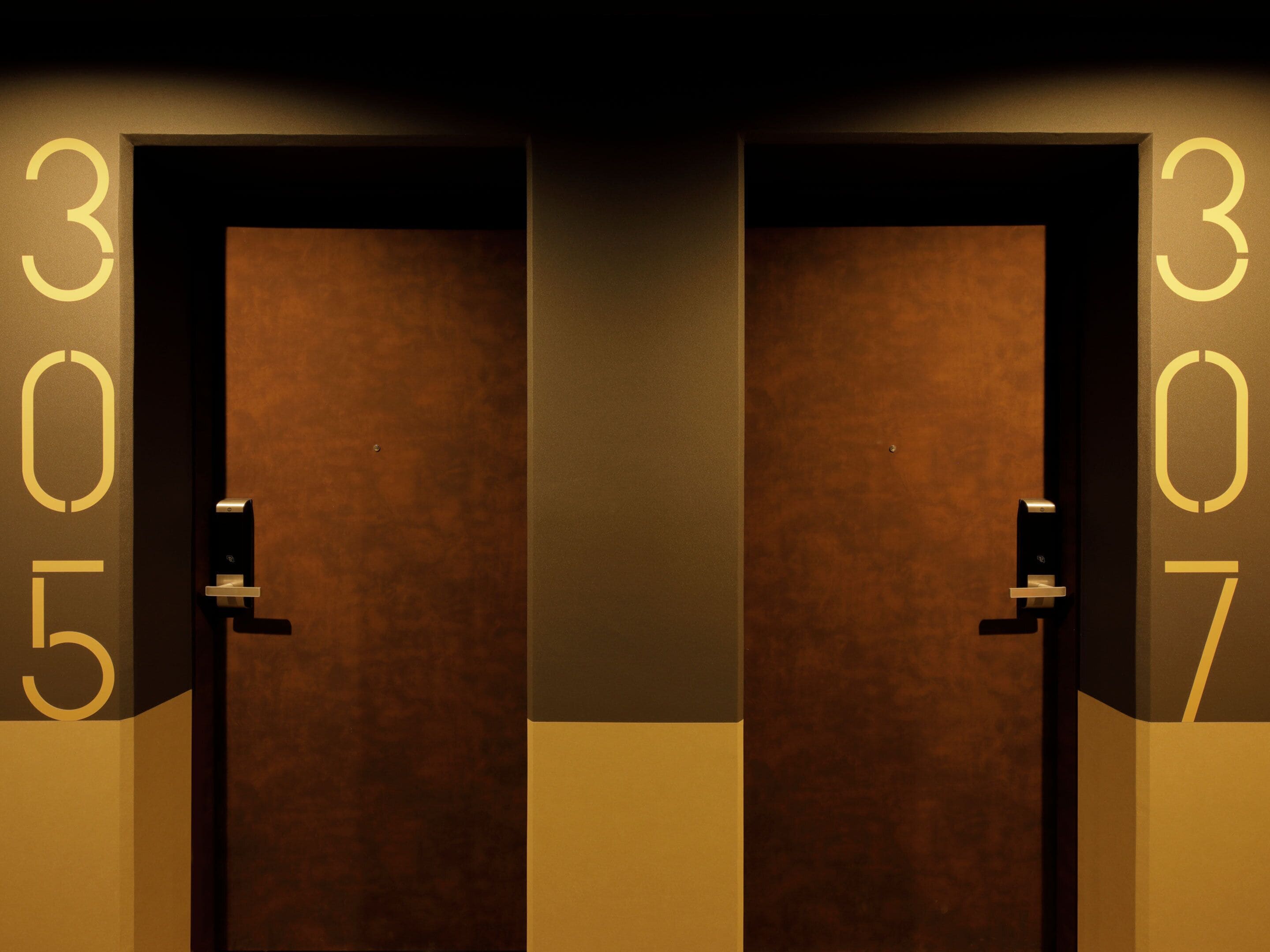 Two doors with numbers 305 and 307, indicating a hotel room numbering system.
