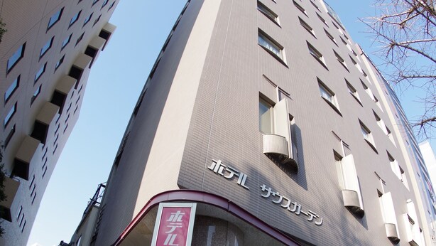 A modern building with a curved facade and a prominent entrance. - Hotel South Garden Hamamatsu (Hamamatsu)