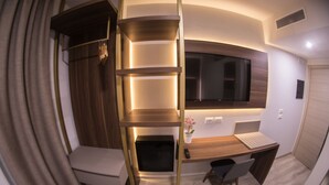 A compact, modern room with a built-in desk, a chair, a small shelf, and a window. - 8 Room Hotel (Catania)