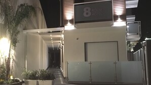 A modern hotel entrance with a sign indicating room number 8. - 8 Room Hotel (Catania)