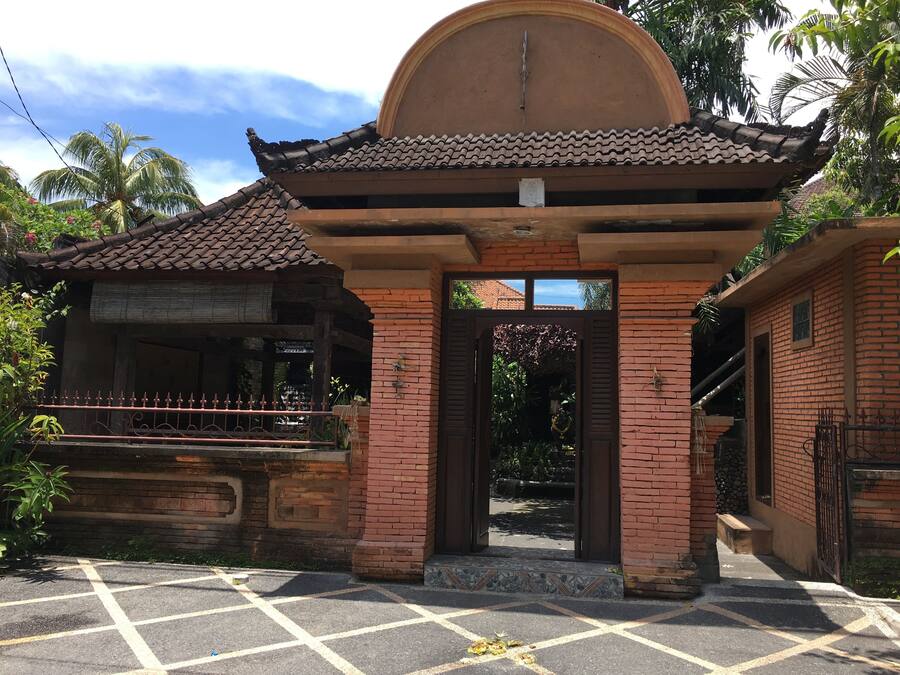 A traditional building with a tiled roof and a central archway.