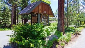 A wooden cabin with a sign reading "Lake Forest Glen".