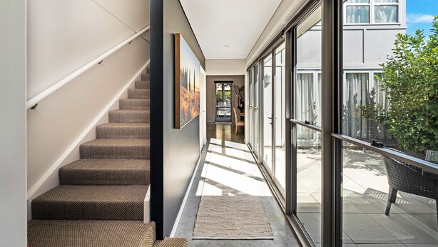 A modern interior with a staircase, large windows, and a view of the outside. - The Hidden Door Bowral Villa - the Heart of Bowral (Bowral)