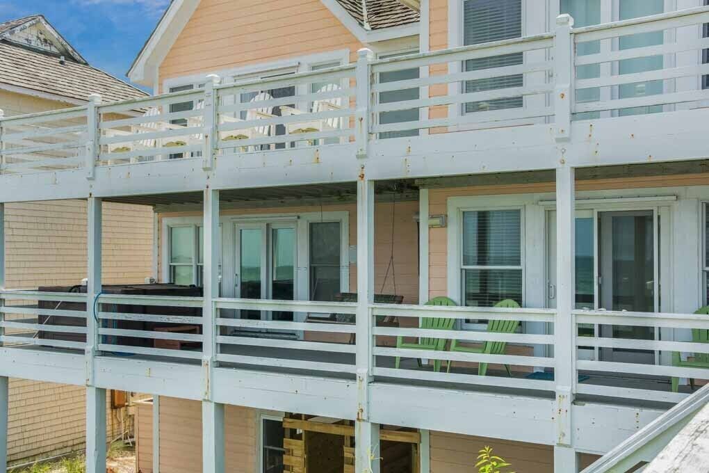 A multi-story building with a balcony on the second floor.