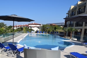 Seasonal outdoor pool, an infinity pool, pool umbrellas, pool loungers