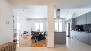 A modern kitchen with grey cabinets, a black countertop, and a built-in oven.