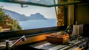 Una cucina con una finestra vista su un lago e montagne.