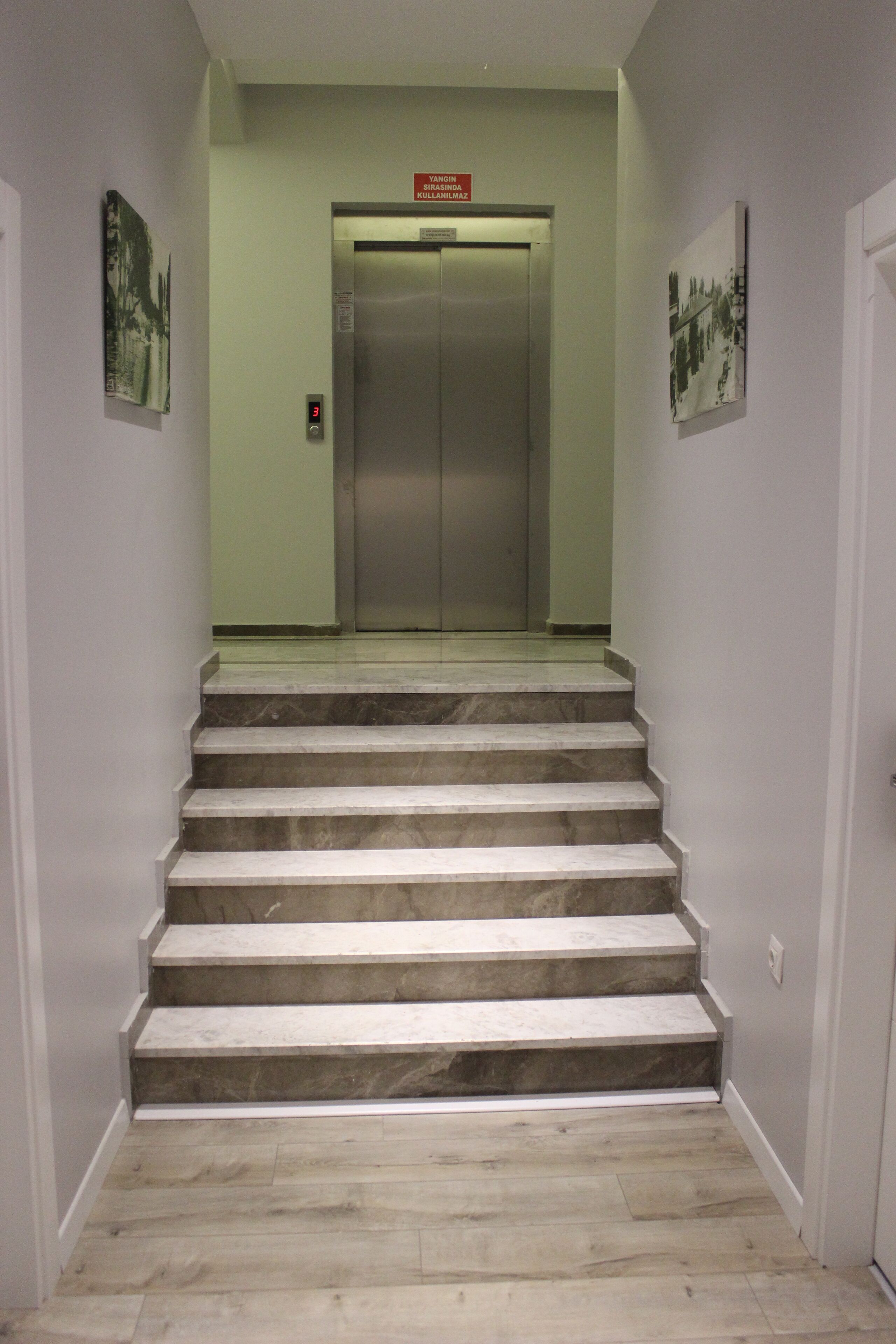 A staircase leading to an elevator in a building.