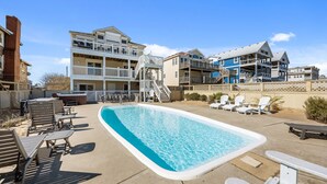 A swimming pool with lounge chairs and a hot tub, surrounded by multi-story buildings with balconies. - Atlantic Watch: Oceanfront | 14 bedrooms | Private Walkway | Heated Private Pool (Kill Devil Hills)
