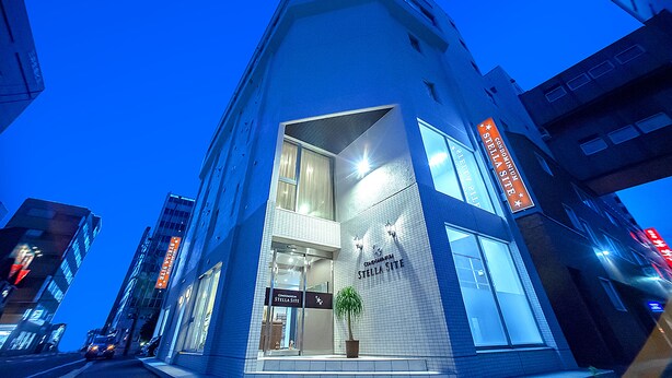 A modern building with a prominent entrance and a sign reading "Stella Site". - Condominium Stella Site (Hakodate)