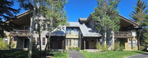 A two-story house with a front porch, a covered entryway, and a visible garage. - Snowcreek Resort Vacation Rental 848 (Mammoth Lakes)