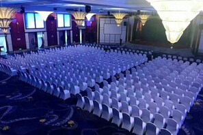 A large hall with rows of white chairs arranged for an event. - Shanghai Jinshanzui Yucun Hotel (Shanghai)