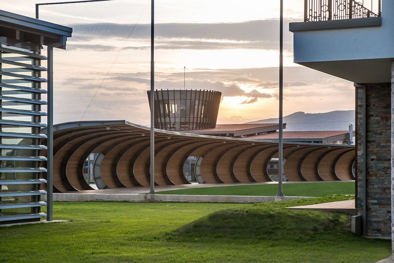 A modern building with a curved facade and a central circular structure.