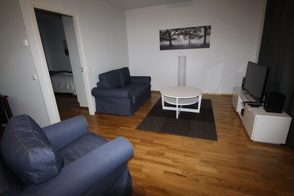 Deluxe Apartment, 1 Bedroom, Sauna | Living room | Flat-screen TV, video game console, heated floors