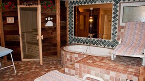 A bathroom with a wooden door, a bathtub, a shower area, and a mirror. - Cesa Rotic (Canazei)