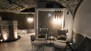 A modern lounge area with stone walls, a stone fireplace, and contemporary seating. - Hotel Villa Sanct Peter (Bad Neuenahr-Ahrweiler)