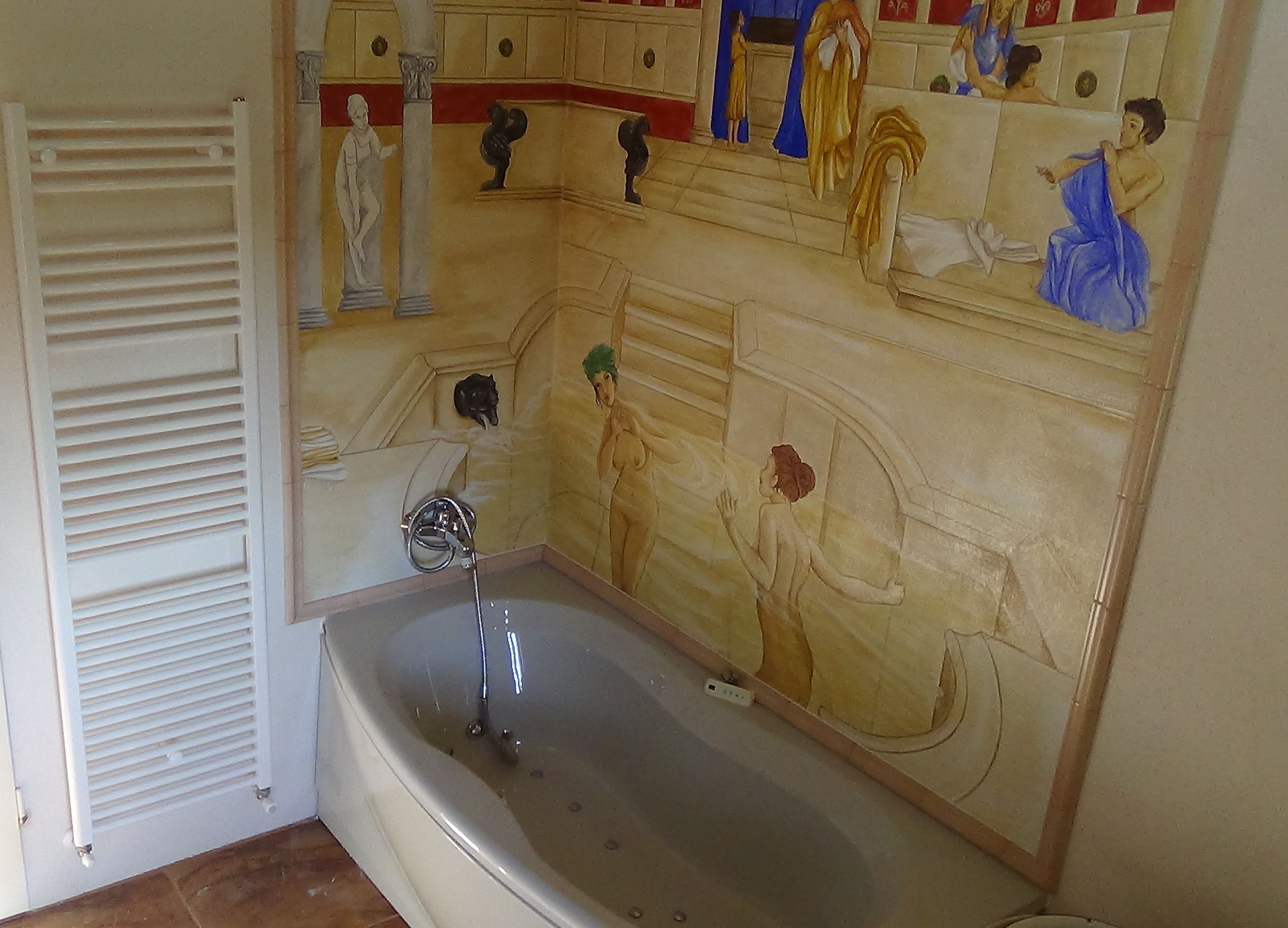 Une salle de bain équipée d’une baignoire, d’une douche et ornée d’une fresque murale représentant des figures de l’Antiquité.