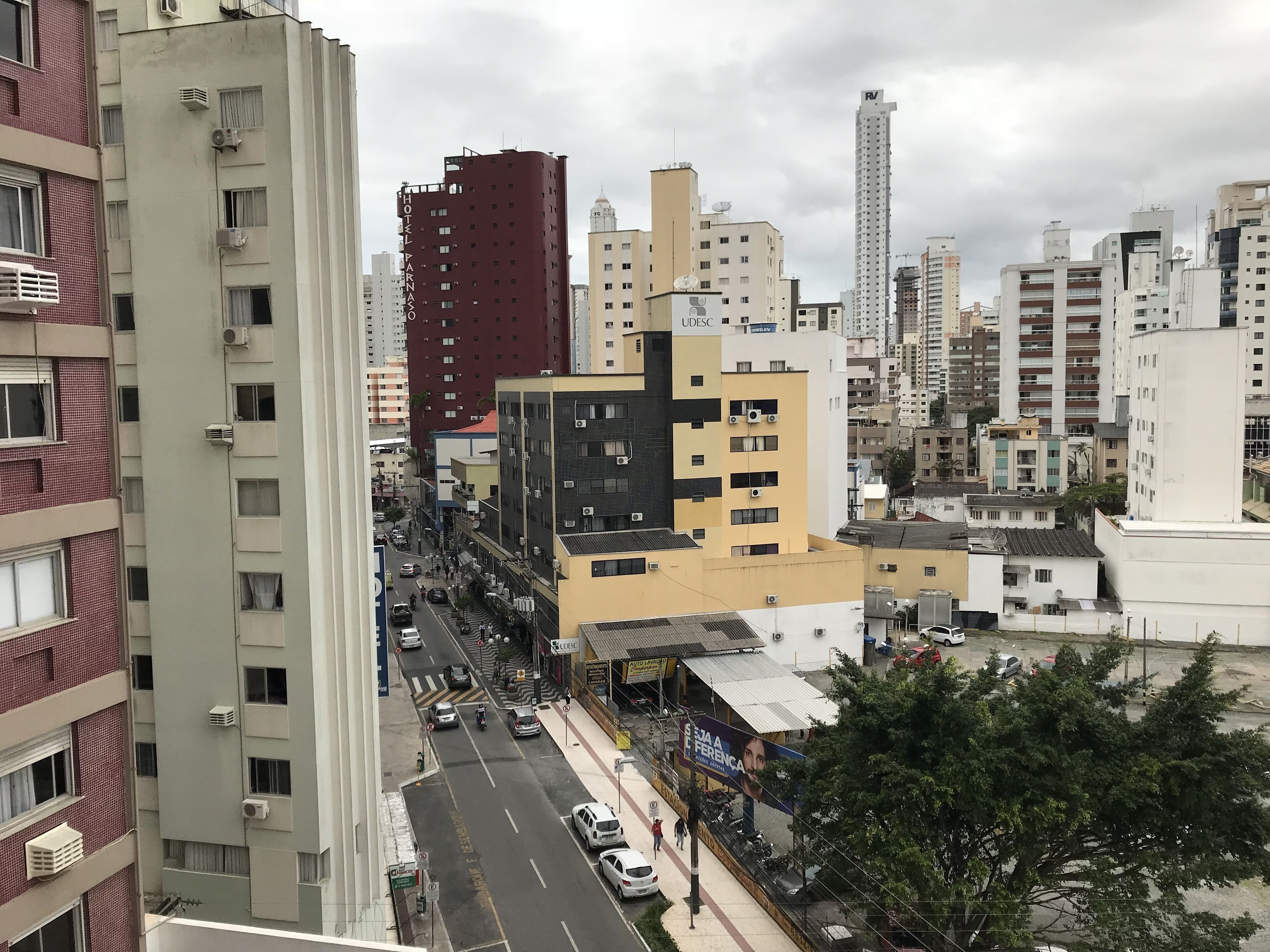 A cityscape with various buildings, including a hotel with a visible sign.