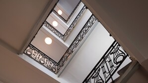 A staircase with ornate black railings and a skylight above. - Doma Zagreb (Zagreb)