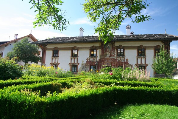 A historic building with a symmetrical facade, multiple windows, and a central balcony. - Mammhofer Suite & Breakfast (Oberammergau)