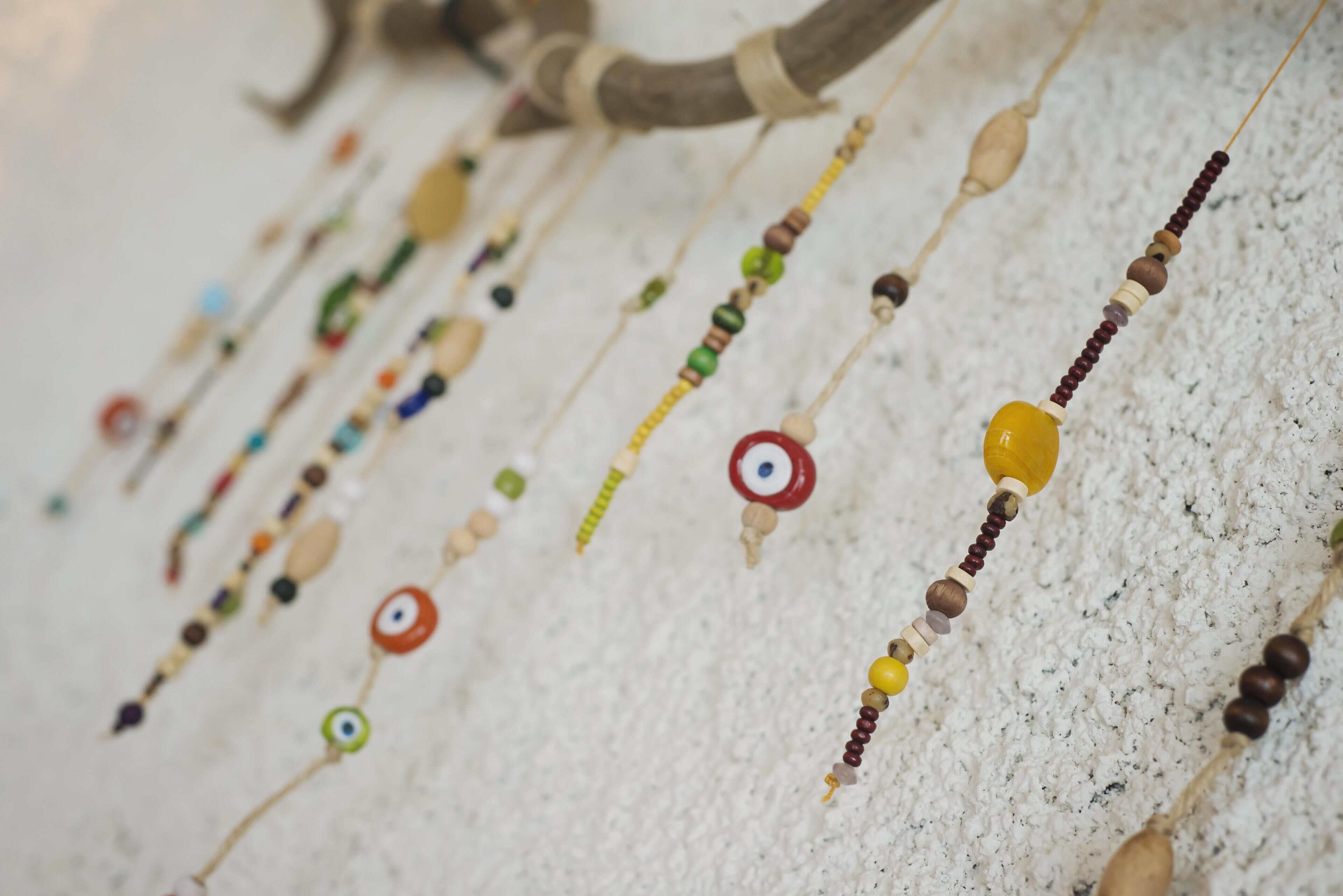A collection of beaded necklaces with various bead colors and shapes.