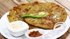 A plate of food with a green chili, a white sauce, and a red sauce. - Airport Hotel Golden Jindal (New Delhi)