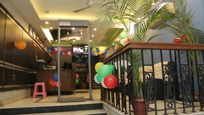 A hotel lobby with a staircase, a reception desk, and a 'Best Price' sign. - Airport Hotel Golden Jindal (New Delhi)