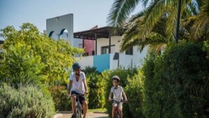 Two people riding bicycles on a paved path surrounded by greenery. - Trilocale - Two Bedroom Apartment, Sleeps 6 (Castellaneta)