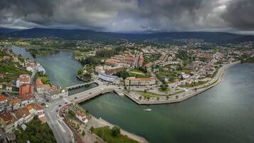 An aerial view of a coastal town with a river, bridges, and residential buildings.