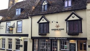 A traditional building with a sign for 'Greene King' and 'Royal Standard' pub. - The Royal Standard (Ely)