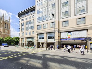 A multi-story building with a large sign for The Broadway, indicating a district and precinct office.